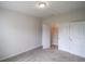 Bright bedroom featuring neutral carpet and a closet with bifold doors for organized storage at 311 Six Mile Creek Dr., Georgetown, SC 29440