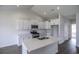 Modern kitchen features quartz countertops, stainless appliances, white cabinets and an island at 311 Six Mile Creek Dr., Georgetown, SC 29440