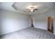 Large main bedroom features a tray ceiling, ceiling fan, and carpeting at 311 Six Mile Creek Dr., Georgetown, SC 29440