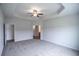 Spacious primary bedroom features a tray ceiling, fan, carpeting, and access to en suite bathroom at 311 Six Mile Creek Dr., Georgetown, SC 29440