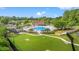 Aerial view of the community pool, playground, and recreational area surrounded by lush greenery and mature trees at 312 Caldera Ct., Murrells Inlet, SC 29576