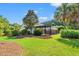 Expansive backyard featuring lush landscaping, a covered patio, and a cozy outdoor dining area at 312 Caldera Ct., Murrells Inlet, SC 29576