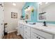 Bright bathroom with double vanity, modern fixtures, and stylish blue accent wall at 312 Caldera Ct., Murrells Inlet, SC 29576