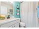 Bright bathroom with a modern vanity, white cabinets, marble countertop, and blue accent wall at 312 Caldera Ct., Murrells Inlet, SC 29576