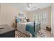 Cozy bedroom featuring a metal bed frame, ceiling fan and plantation shutters for bright natural light at 312 Caldera Ct., Murrells Inlet, SC 29576