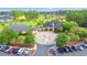Aerial view of the clubhouse featuring beautiful architecture, a circular driveway, and a large parking area at 312 Caldera Ct., Murrells Inlet, SC 29576