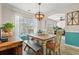 Inviting dining room featuring an elegant light fixture, bench seating, and ample natural light at 312 Caldera Ct., Murrells Inlet, SC 29576
