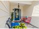 Cozy front porch with a blue door, seating, and decorative accents creating a welcoming entrance at 312 Caldera Ct., Murrells Inlet, SC 29576