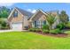 Charming brick home with well-manicured lawn and inviting curb appeal, featuring a two-car garage and blue shutters at 312 Caldera Ct., Murrells Inlet, SC 29576
