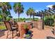 Outdoor kitchen area with a built-in grill, brick accents, and shaded pergola at 312 Caldera Ct., Murrells Inlet, SC 29576