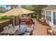 Brick patio with outdoor kitchen, pergola, dining table, and comfortable seating, perfect for entertaining at 312 Caldera Ct., Murrells Inlet, SC 29576