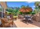 Brick patio with outdoor seating, an umbrella-covered table, and a wrought-iron gate leading to the backyard at 312 Caldera Ct., Murrells Inlet, SC 29576