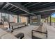 Outdoor patio area with comfortable seating, a fireplace, and a TV, perfect for relaxing and entertaining at 312 Caldera Ct., Murrells Inlet, SC 29576