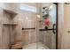 Bathroom shower featuring a glass door, tiled walls, and built-in shelving at 312 Caldera Ct., Murrells Inlet, SC 29576