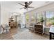 A sunroom with natural light, stylish furnishings, and a view to the dining area at 312 Caldera Ct., Murrells Inlet, SC 29576