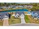 Aerial view of a home with a well-manicured lawn, pool, and pond at 318 Board Landing Circle, Conway, SC 29526