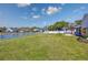 Large backyard featuring a pond view, patio with pergola, and ample green space at 318 Board Landing Circle, Conway, SC 29526