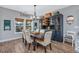 Stylish dining room featuring a modern chandelier, a beautiful hutch, and lots of natural light at 318 Board Landing Circle, Conway, SC 29526