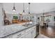 Open-concept kitchen with stainless steel appliances, granite counters, island with seating, and seamless flow to living areas at 318 Board Landing Circle, Conway, SC 29526