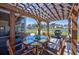 Charming outdoor patio with a pergola, dining table, and views of a serene pond and well-maintained backyard at 318 Board Landing Circle, Conway, SC 29526