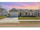 Charming single-story home featuring a two-car garage, well-manicured lawn and beautiful front yard landscaping at 3231 Little Bay Dr., Conway, SC 29526