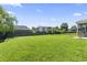 Expansive grassy back yard with a partial view of the home's patio and black aluminum fencing at 4136 Alvina Way, Myrtle Beach, SC 29579