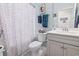 Cozy bathroom features a toilet, shower, vanity and sink, and soft blue walls at 4136 Alvina Way, Myrtle Beach, SC 29579