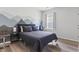Serene bedroom features a mountain mural, wood floors, and neutral decor at 4136 Alvina Way, Myrtle Beach, SC 29579