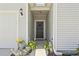 Inviting entryway with a black front door, decorative plants, and exterior lighting at 4136 Alvina Way, Myrtle Beach, SC 29579