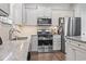 Bright kitchen featuring granite countertops, stainless steel appliances, and shaker style cabinets at 4136 Alvina Way, Myrtle Beach, SC 29579