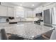 Spacious kitchen with white cabinets, granite countertops, stainless steel appliances, and hardwood flooring at 4136 Alvina Way, Myrtle Beach, SC 29579