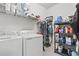 Bright laundry room with washer, dryer, shelving, and storage racks at 4136 Alvina Way, Myrtle Beach, SC 29579