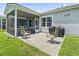 View of a patio area with grill and outdoor seating connected to the home's screened-in porch at 4136 Alvina Way, Myrtle Beach, SC 29579