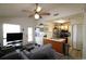 Comfortable living room boasting ceiling fan and adjoining open kitchen with stainless appliances at 423 Tree Top Ct. # 23-B, Myrtle Beach, SC 29588
