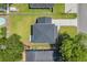 Aerial view of property featuring well-maintained lawn, concrete driveway, and mature trees at 4329 Landing Rd., Little River, SC 29566