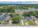 An aerial shot features a neighborhood surrounded by mature trees and lush landscapes at 4329 Landing Rd., Little River, SC 29566