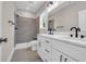 Bathroom featuring double vanity, tiled shower with a shower bench, and black modern accents at 4329 Landing Rd., Little River, SC 29566