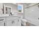 A bathroom has a white vanity with black hardware and a toilet next to a tub-shower combo at 4329 Landing Rd., Little River, SC 29566