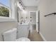 Bathroom featuring a double vanity, large mirror, modern lighting, and tiled floors at 4329 Landing Rd., Little River, SC 29566