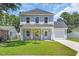 Charming two-story home with a manicured lawn, covered porch, and attached garage at 4329 Landing Rd., Little River, SC 29566