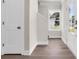 Bright foyer with wood floors, a staircase, a large window, and a classic white door at 4329 Landing Rd., Little River, SC 29566