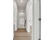 Long hallway with light-colored walls and wood-look flooring connecting the rooms at 4329 Landing Rd., Little River, SC 29566