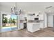 Modern kitchen with white cabinets, an island, and sliding glass doors to outdoor space at 4329 Landing Rd., Little River, SC 29566