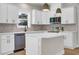 Bright kitchen featuring white cabinets, stainless steel appliances, and a center island with countertop at 4329 Landing Rd., Little River, SC 29566