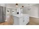 Island with quartz countertop between kitchen, living room, and fireplace creating an open floor plan at 4329 Landing Rd., Little River, SC 29566
