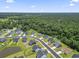 Community aerial shot showcasing the neighborhood layout, green spaces, and surrounding trees and pond at 437 Shallow Cove Dr., Conway, SC 29527