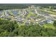 A wide shot of a neighborhood and surrounding green spaces, including multiple community ponds at 437 Shallow Cove Dr., Conway, SC 29527