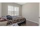 A cozy bedroom is illuminated by natural light, featuring a window and light gray walls at 437 Shallow Cove Dr., Conway, SC 29527