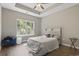 Inviting bedroom featuring a large window, tray ceilings, and wood-look floors for a relaxing atmosphere at 437 Shallow Cove Dr., Conway, SC 29527