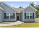 Inviting entrance of a home featuring blue shutters, a covered porch, and a neatly landscaped yard at 437 Shallow Cove Dr., Conway, SC 29527